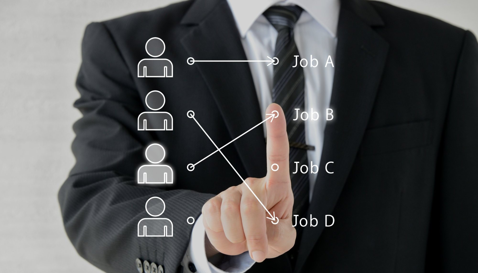 Businessman pointing to a digital diagram that matches team members to different jobs