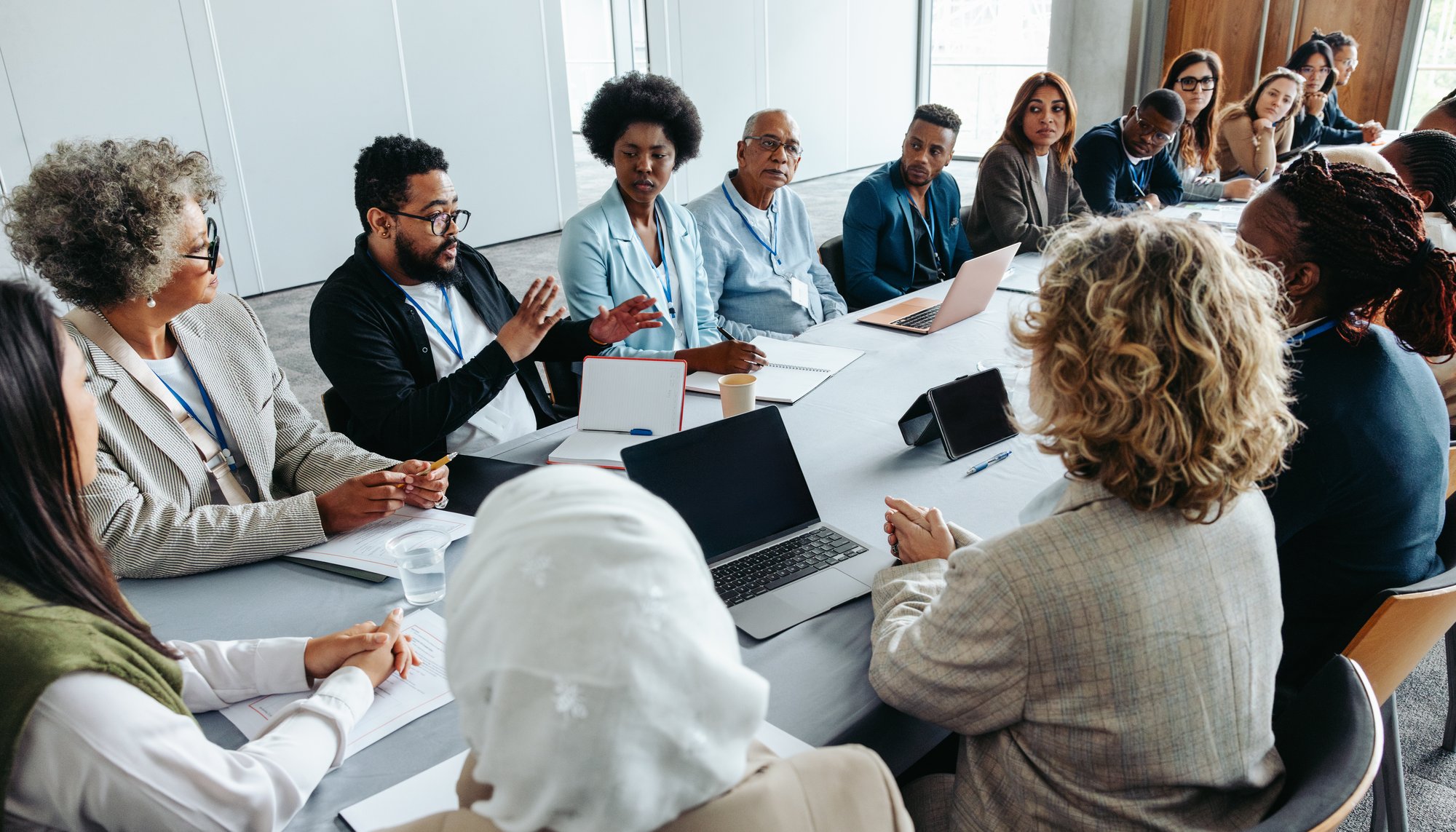 Diverse team discussing ideas around conference table